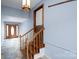 Inviting entryway with wood staircase, light fixture, and tile flooring offers a warm welcome at 47209 Paradise Ln, Norwood, NC 28128