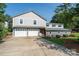 Charming home featuring a two-car garage and well-maintained front lawn, offering both convenience and curb appeal at 47209 Paradise Ln, Norwood, NC 28128