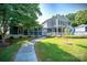 Beautiful two-story home featuring a spacious yard, screened porch, and a welcoming entrance at 47209 Paradise Ln, Norwood, NC 28128