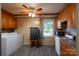 Functional kitchen space with laundry machine, appliances and window at 47209 Paradise Ln, Norwood, NC 28128