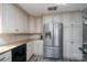 Bright kitchen featuring stainless steel refrigerator and ample cabinet space at 47209 Paradise Ln, Norwood, NC 28128