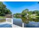 Scenic lake view with docks and lush trees creating a serene waterfront panorama at 47209 Paradise Ln, Norwood, NC 28128