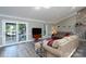 Comfortable living room with access to an outdoor patio and a view of the stone fireplace at 47209 Paradise Ln, Norwood, NC 28128