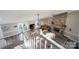 Open-concept living space with vaulted ceilings, stone fireplace and access to the kitchen and outdoor patio at 47209 Paradise Ln, Norwood, NC 28128