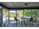 Relaxing screened-in porch with bar-height table and chairs, offering scenic lake views at 47209 Paradise Ln, Norwood, NC 28128