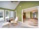 Bright sunroom with lake views and access to the bedroom and other rooms at 47209 Paradise Ln, Norwood, NC 28128