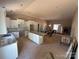 Open-concept kitchen with white cabinets, granite countertops, and an island, flowing into a living area with a fireplace at 4940 Southview Dr, Hickory, NC 28602