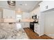 View of kitchen featuring granite counters, white cabinets, and stainless steel appliances at 4940 Southview Dr, Hickory, NC 28602