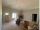 Unfinished living room featuring a brick fireplace, a door to the outside, and large window awaiting flooring at 4940 Southview Dr, Hickory, NC 28602