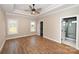 Spacious main bedroom features tray ceiling, fan, wood floors, two windows, and ensuite bathroom at 4940 Southview Dr, Hickory, NC 28602