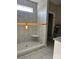 Newly renovated shower with gray and white marble-style tiling and a corner shelf at 4940 Southview Dr, Hickory, NC 28602