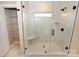 Glass shower features black fixtures, shower seat, and storage shelf, providing luxurious experience at 4940 Southview Dr, Hickory, NC 28602