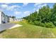 A spacious backyard offers room to roam with views of green space and neighboring homes at 5010 Arbordale Way, Mount Holly, NC 28120