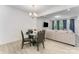 Dining area with modern table set near the living room with luxury vinyl plank flooring at 5010 Arbordale Way, Mount Holly, NC 28120