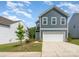 Charming two-story home with blue siding and a well-maintained front yard at 5010 Arbordale Way, Mount Holly, NC 28120