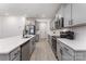 Spacious kitchen featuring gray cabinets, stainless steel appliances, and a large island at 5010 Arbordale Way, Mount Holly, NC 28120