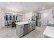 Modern kitchen with gray cabinets, a large island, and stainless steel appliances at 5010 Arbordale Way, Mount Holly, NC 28120