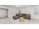 Bright living room with a plush sectional sofa, gold accent table, and neutral carpet flooring at 5010 Arbordale Way, Mount Holly, NC 28120