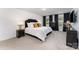 Elegant main bedroom with a luxurious bed, stylish black furniture, and natural light from large windows at 5010 Arbordale Way, Mount Holly, NC 28120