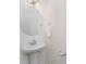 Clean and modern powder room with pedestal sink and round mirror at 5010 Arbordale Way, Mount Holly, NC 28120