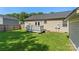 Backyard showcasing the house, a wooden deck with stairs, and a lush green lawn at 5206 Crane Point Dr, Charlotte, NC 28227