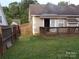 Cozy backyard featuring a wooden deck, small awning, and a well-maintained lawn at 569 River View Dr, Lowell, NC 28098