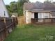 Backyard view with the deck, awning, home, and a wood fence at 569 River View Dr, Lowell, NC 28098