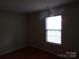 Bedroom with hardwood flooring and natural light streaming through the window at 569 River View Dr, Lowell, NC 28098