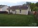 Exterior shot of home with deck, awning, siding, and wooden fence at 569 River View Dr, Lowell, NC 28098