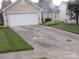 Tan single-story home with two-car garage and well-maintained landscaping at 569 River View Dr, Lowell, NC 28098