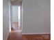 Hallway with wood floors and open doorways leading to other rooms at 569 River View Dr, Lowell, NC 28098