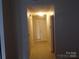 Inviting hallway with tile flooring leading to a bright and airy entryway at 569 River View Dr, Lowell, NC 28098