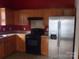 Well-equipped kitchen featuring wood cabinets and stainless steel refrigerator at 569 River View Dr, Lowell, NC 28098