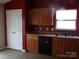 Functional kitchen with wood cabinets and modern black appliances at 569 River View Dr, Lowell, NC 28098