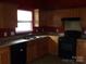 Kitchen view of cabinets, laminate countertops, an oven, and a window at 569 River View Dr, Lowell, NC 28098