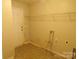 Well-lit laundry room featuring hookups and shelving for efficient organization at 569 River View Dr, Lowell, NC 28098