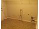 Functional laundry area with essential connections and storage space at 569 River View Dr, Lowell, NC 28098