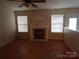 Spacious living room with a classic fireplace and ample natural light at 569 River View Dr, Lowell, NC 28098