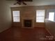 Inviting living room with fireplace and natural light from two large windows at 569 River View Dr, Lowell, NC 28098