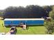 Aerial view of the property showcasing a well-kept blue house with a spacious yard and driveway at 589 Owls Den Rd, Lincolnton, NC 28092