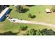 Aerial view shows the property with spacious green land, a long driveway, a house, outbuildings and vehicle parking at 589 Owls Den Rd, Lincolnton, NC 28092