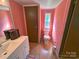 Bathroom with neutral color scheme and ample counter space, toilet and window at 589 Owls Den Rd, Lincolnton, NC 28092