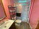 Bathroom features modern toilet and shower with shelving for storage at 589 Owls Den Rd, Lincolnton, NC 28092
