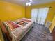 Bedroom features wood-look floors, ceiling fan and a window providing natural light at 589 Owls Den Rd, Lincolnton, NC 28092