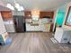 Well-equipped kitchen with stainless steel refrigerator, good lighting and nice floors at 589 Owls Den Rd, Lincolnton, NC 28092