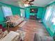 Comfortable living room with wood floors, ceiling fan, and entertainment center at 589 Owls Den Rd, Lincolnton, NC 28092