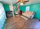 Living room features wood-look floors, ceiling fan and cozy seating at 589 Owls Den Rd, Lincolnton, NC 28092