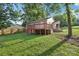 Exterior shot of backyard with wooden deck and fenced perimeter at 603 Paradise St, Monroe, NC 28112
