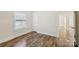 Well-lit bedroom featuring hardwood floors, window, and white door at 603 Paradise St, Monroe, NC 28112