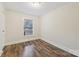 Bright bedroom with wood floors, clean lines and a single window at 603 Paradise St, Monroe, NC 28112